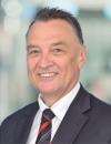 A photo of the Hon Dr Craig Emerson wearing a dark suit.
