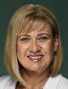 An image of he Hon Justine Elliot MP wearing a white suit.